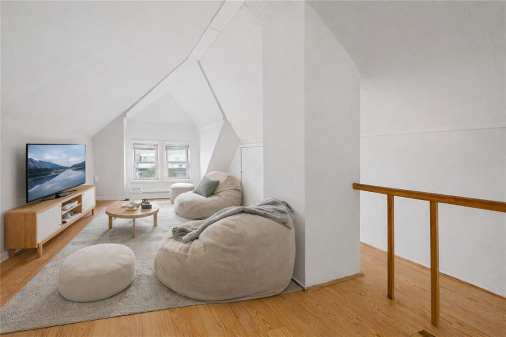 883 Manor Road Staten Island, NY 10314 - Photo 22 of 24 a living room with furniture and a flat screen tv