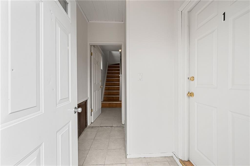 883 Manor Road Staten Island, NY 10314 - Photo 3 of 24 a view of a hallway with a wooden cabinets