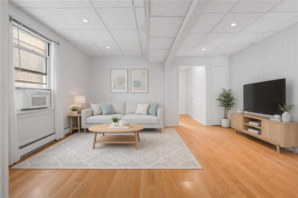 883 Manor Road Staten Island, NY 10314 - Photo 4 of 24 a living room with furniture and a flat screen tv