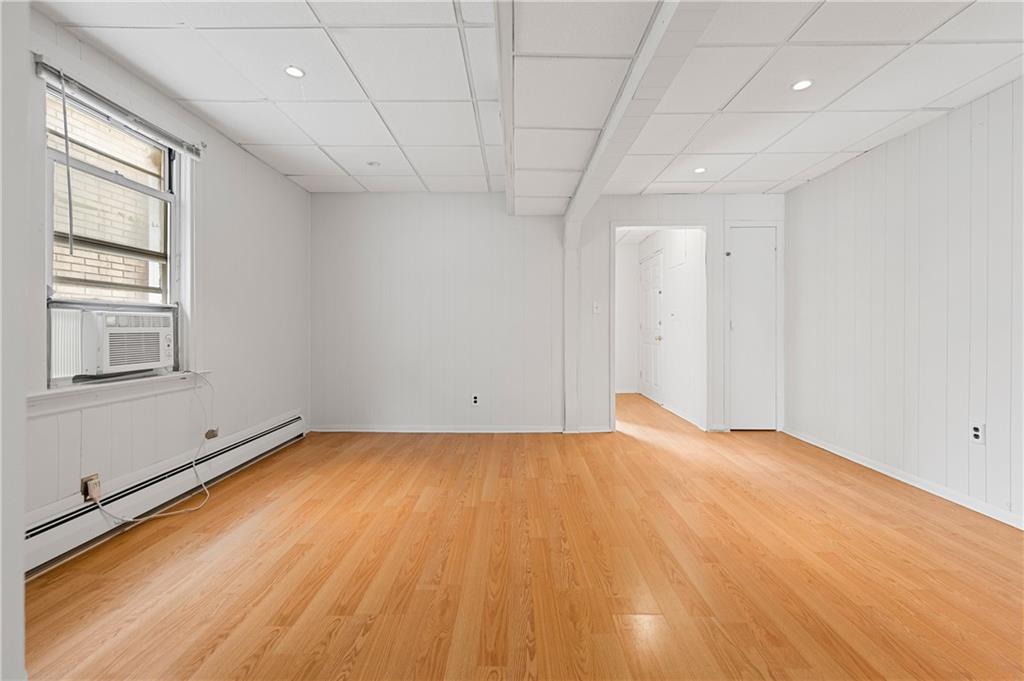 883 Manor Road Staten Island, NY 10314 - Photo 5 of 24 a view of empty room with wooden floor and fan