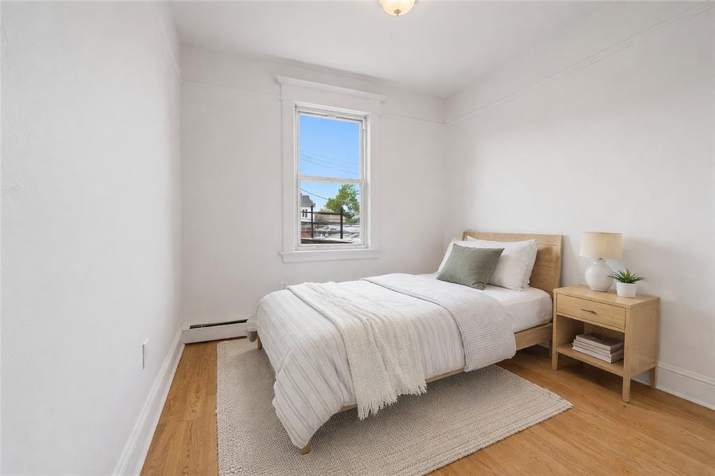 883 Manor Road Staten Island, NY 10314 - Photo 7 of 24 a bedroom with a bed and a window