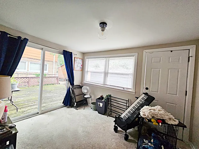 a room with gym equipment and large windows