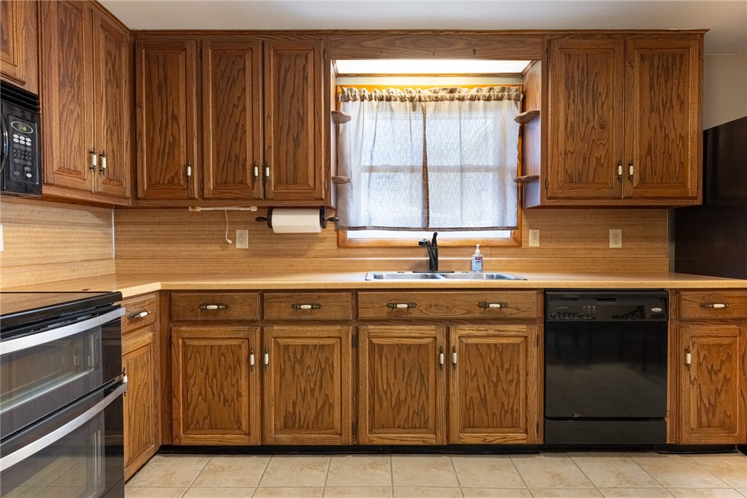 5235 West Ridgewood Road Springfield, OH 45503 - Photo 9 of 32 This kitchen offers functional cabinetry, a double oven, and essential appliances for everyday living.