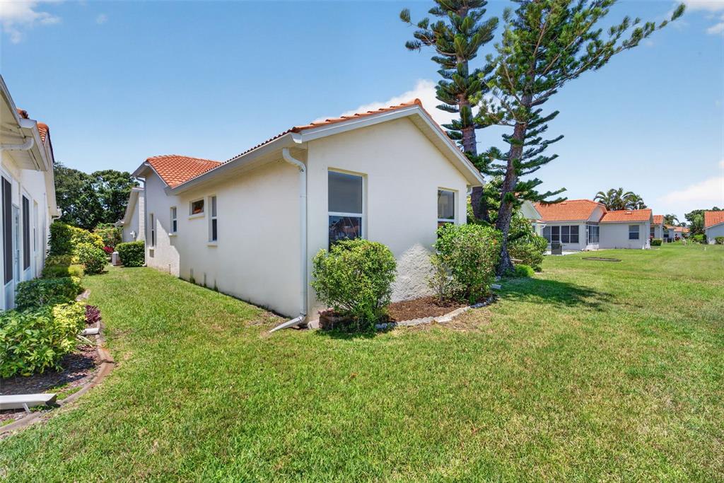 4266 Summertree Road Venice, FL 34293 - Photo 37 of 64 a front view of house with yard and green space