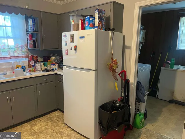 a white refrigerator freezer sitting inside of a kitchen