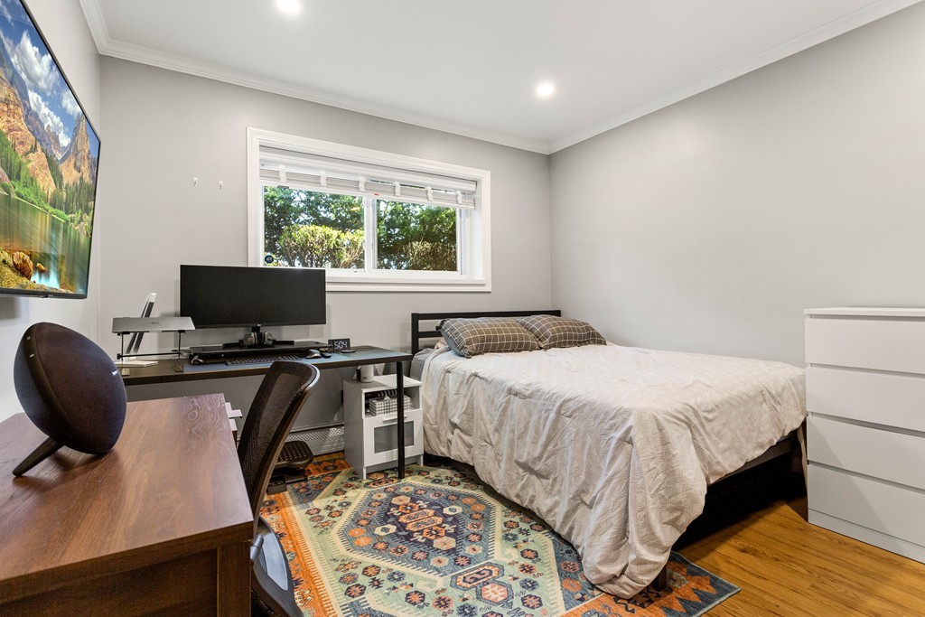 412 Langley Road, Unit 3 Newton, MA 02459 - Photo 21 of 30 a bedroom with a bed and a flat screen tv