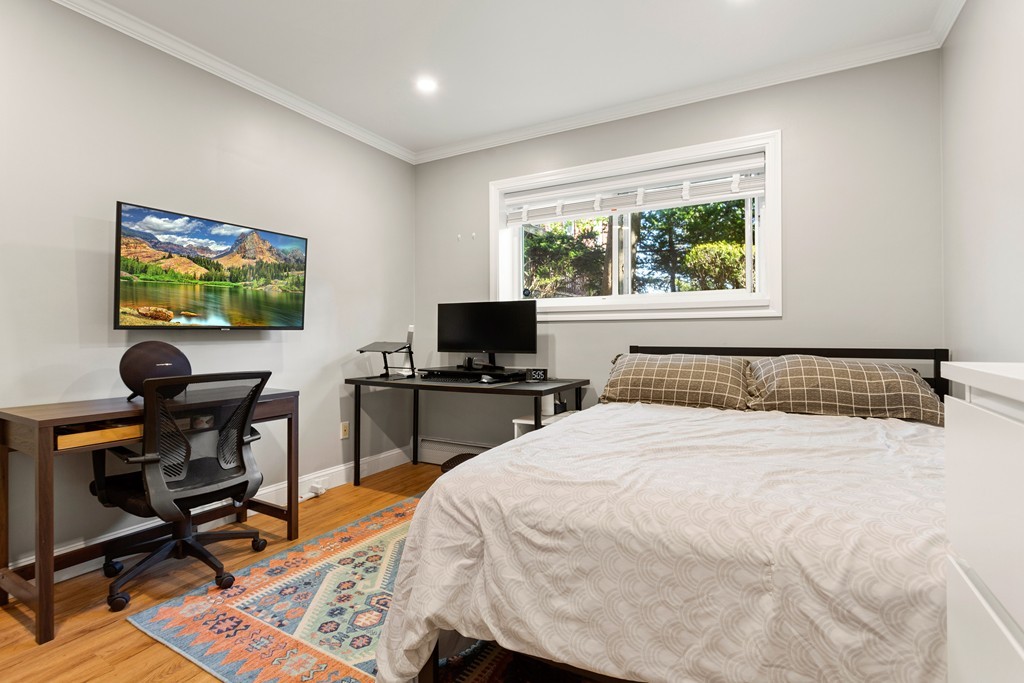 412 Langley Road, Unit 3 Newton, MA 02459 - Photo 22 of 30 a bedroom with a bed and a flat screen tv