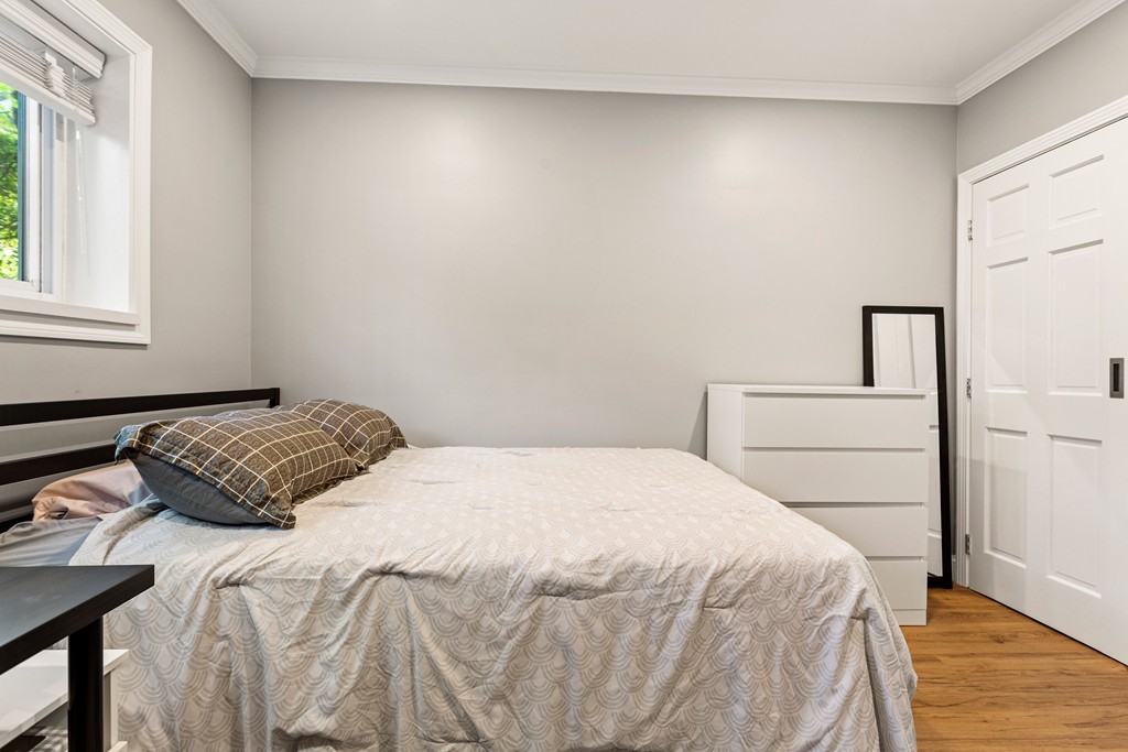412 Langley Road, Unit 3 Newton, MA 02459 - Photo 23 of 30 a bedroom with a bed and a window
