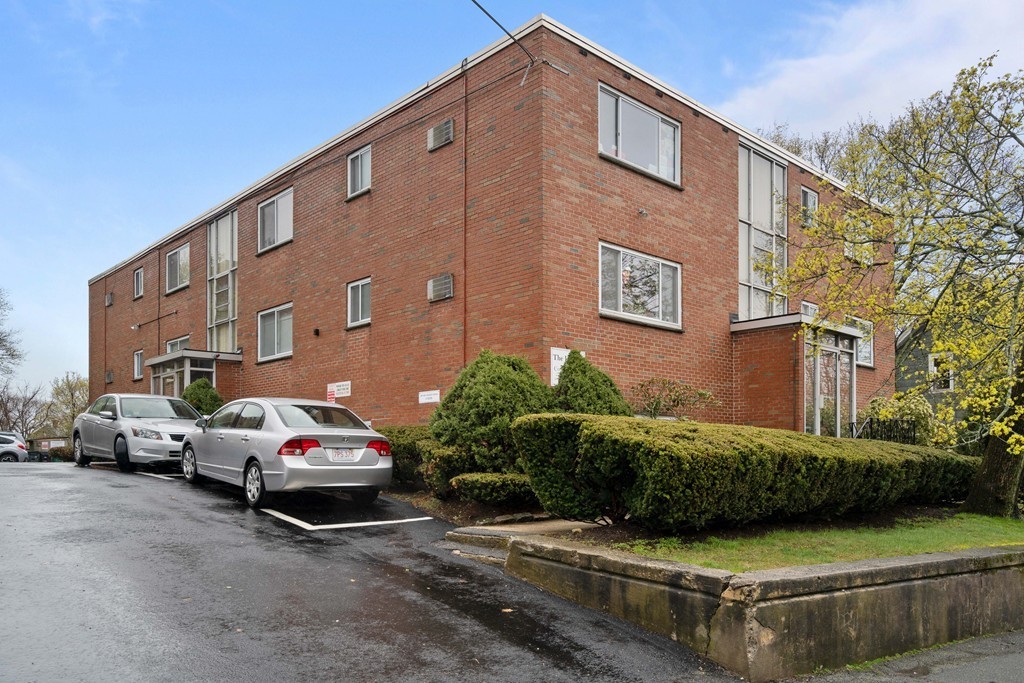 412 Langley Road, Unit 3 Newton, MA 02459 - Photo 28 of 30 a view of a cars park in front of a building