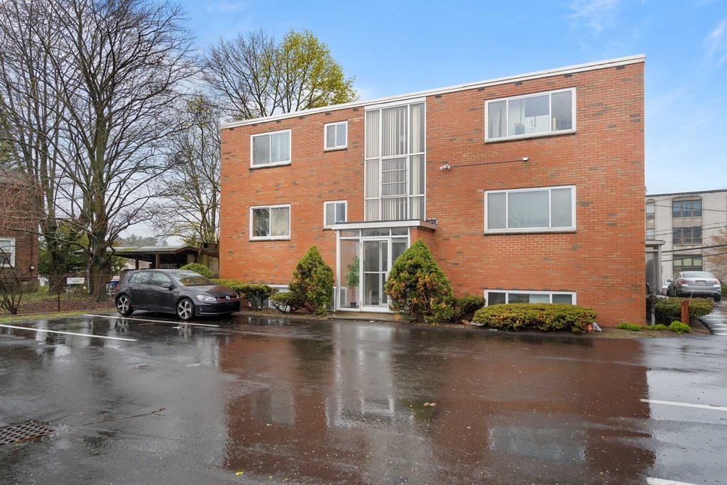 412 Langley Road, Unit 3 Newton, MA 02459 - Photo 29 of 30 a front view of a house with lots of water fountain and trees
