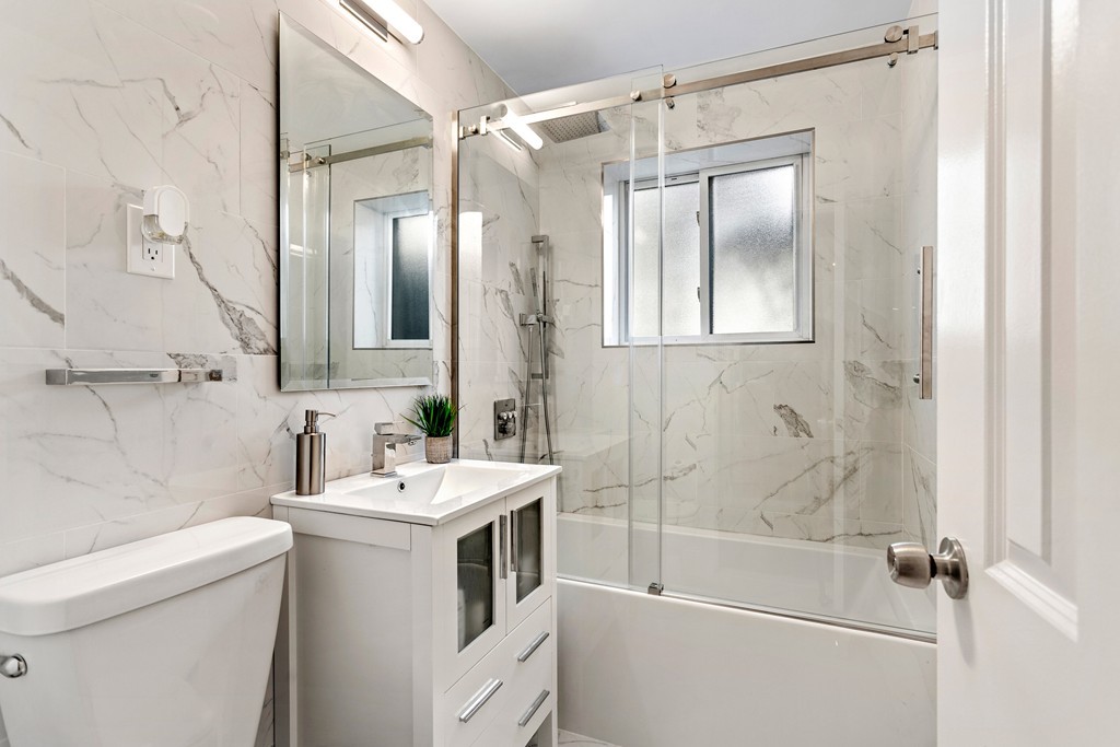 412 Langley Road, Unit 3 Newton, MA 02459 - Photo 8 of 30 a bathroom with a sink toilet tub and shower