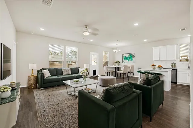 a living room with furniture kitchen and a table