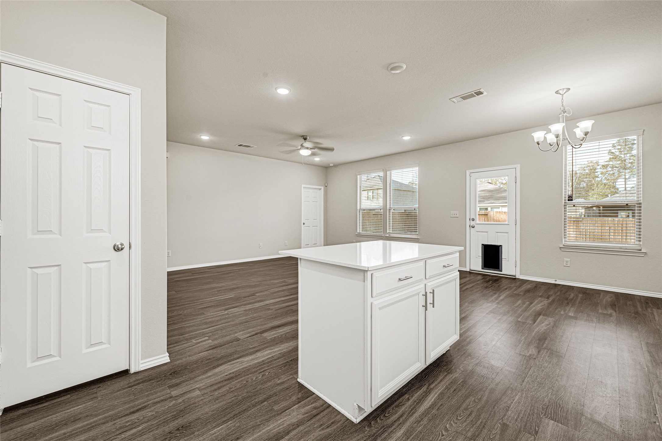 2210 Timberland Country Court Conroe, TX 77304 - Photo 13 of 25 an empty room with wooden floor cabinet and windows
