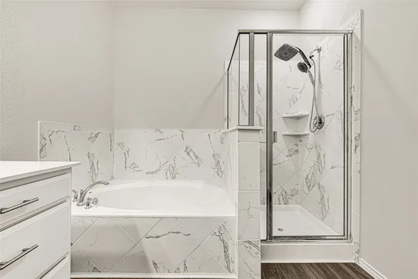 a bathroom with a bathtub and shower