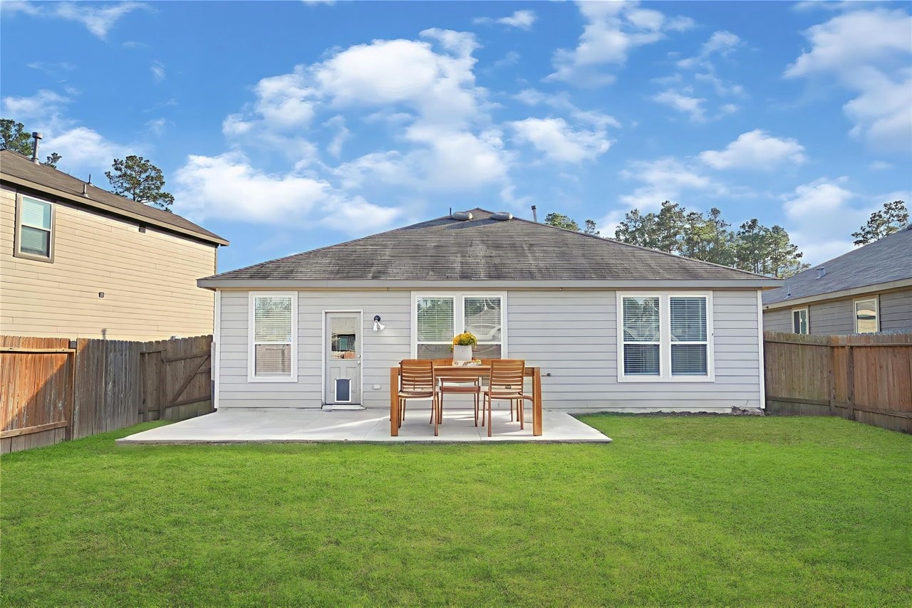 2210 Timberland Country Court Conroe, TX 77304 - Photo 23 of 25 a front view of house with yard and outdoor seating