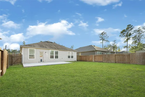 a view of a house with a yard and sitting area