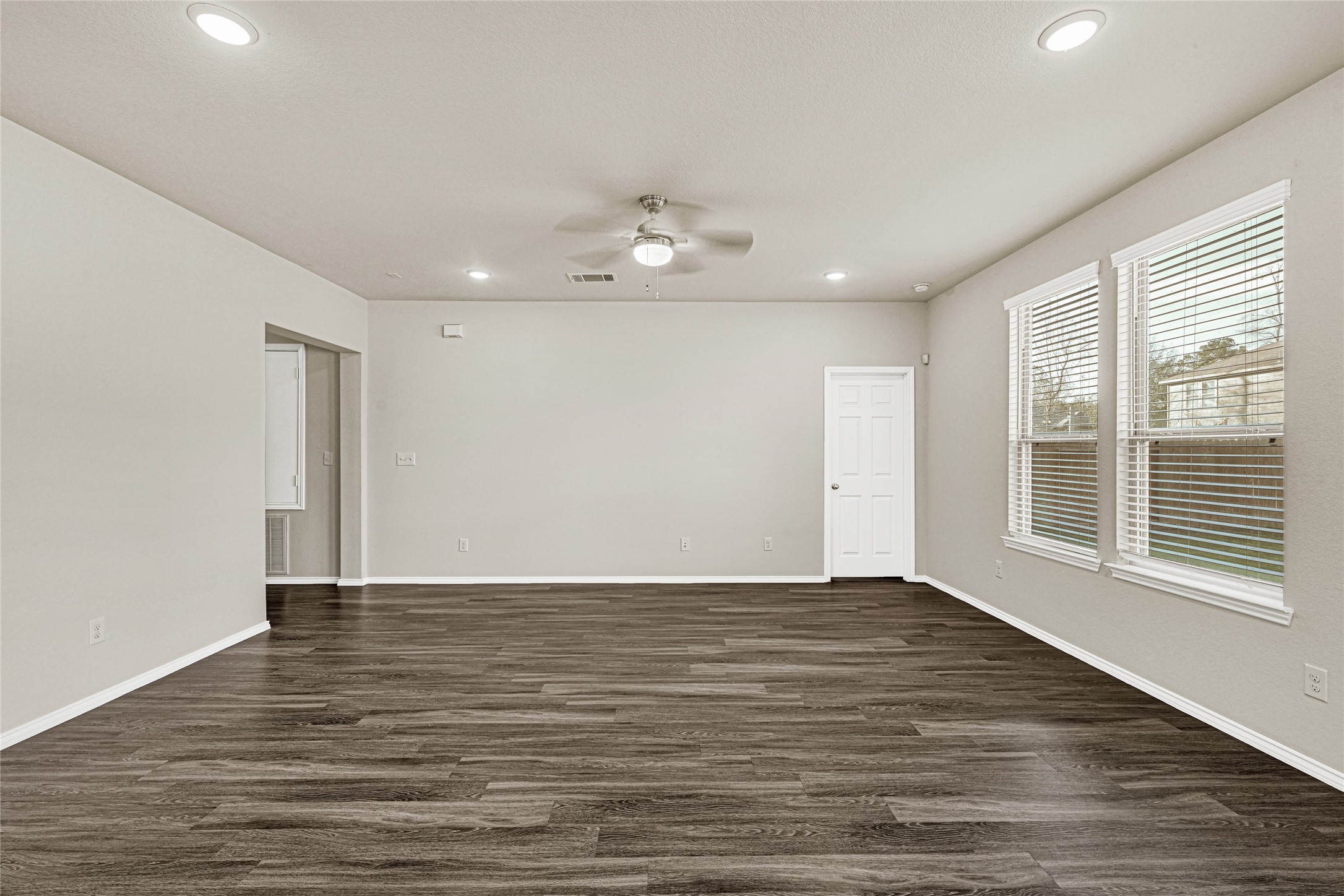 2210 Timberland Country Court Conroe, TX 77304 - Photo 9 of 25 a view of an empty room with wooden floor and a window