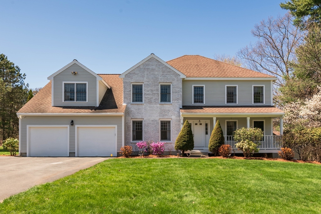 15 Ministers Way Stow, MA 01775 - Photo 2 of 22 a front view of a house with a garden and trees