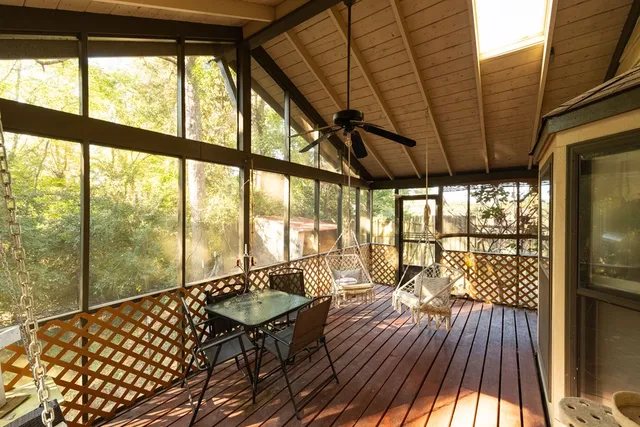 a view of a room with wooden floor and furniture