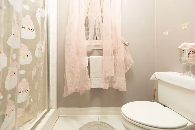 a white toilet sitting next to a bathroom sink