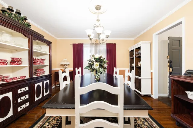 a view of a dining room with furniture and chandelier