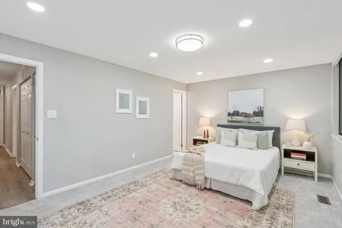 a bedroom with a bed and a lamp