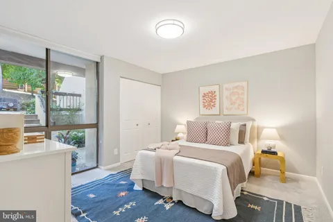 a bedroom with a large bed and a window