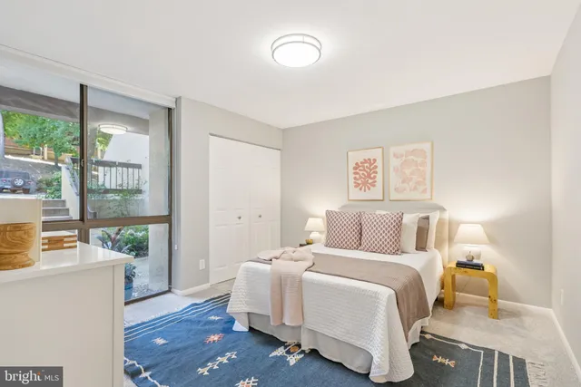 a bedroom with a large bed and a window