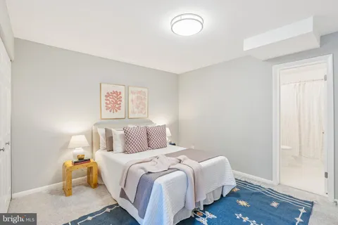 a bedroom with a bed and painting on the wall