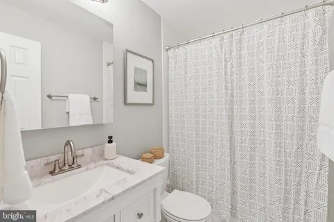 a bathroom with a sink toilet and vanity