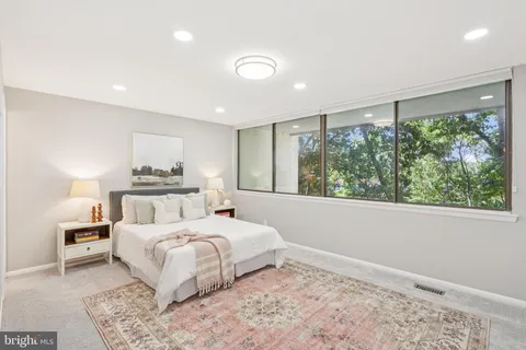 a bedroom with a large bed and a large window