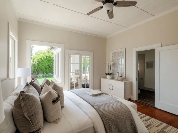 a spacious bedroom with a bed and a chandelier