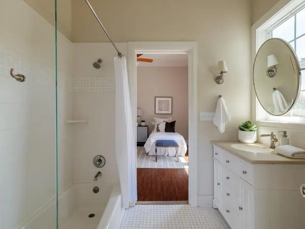 a en suite bathroom with a sink a mirror and a shower