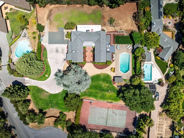 an aerial view of a house with a garden and swimming pool