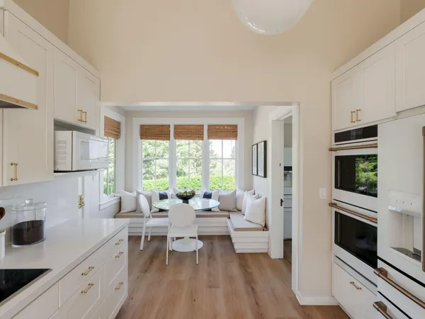 a living room with furniture large window and flat screen tv