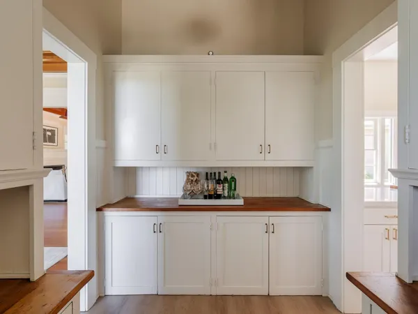 a kitchen with white cabinets and a sink