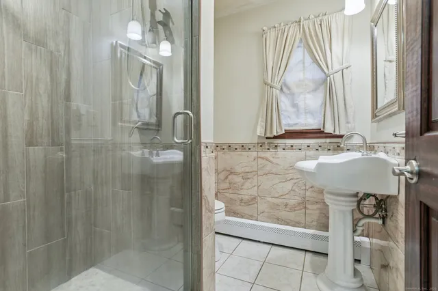 a bathroom with a mirror a sink and a shower