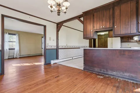 a view of a kitchen with wooden floor and a sink