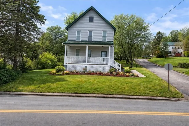 a front view of a house with a yard