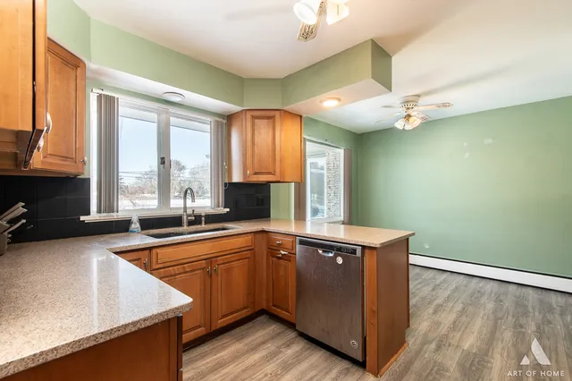 a kitchen with stainless steel appliances granite countertop a sink and a stove