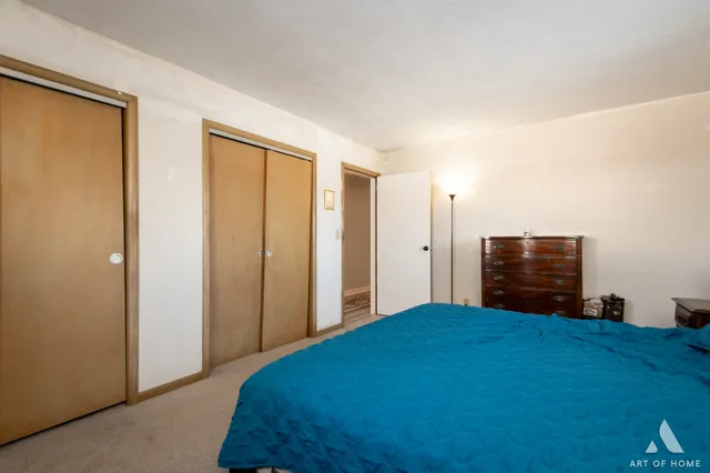 a bedroom with a bed and a dresser