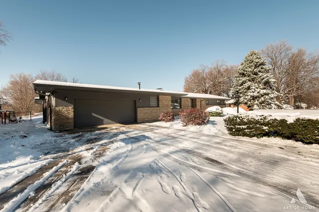 a view of a house with a snow in the yard