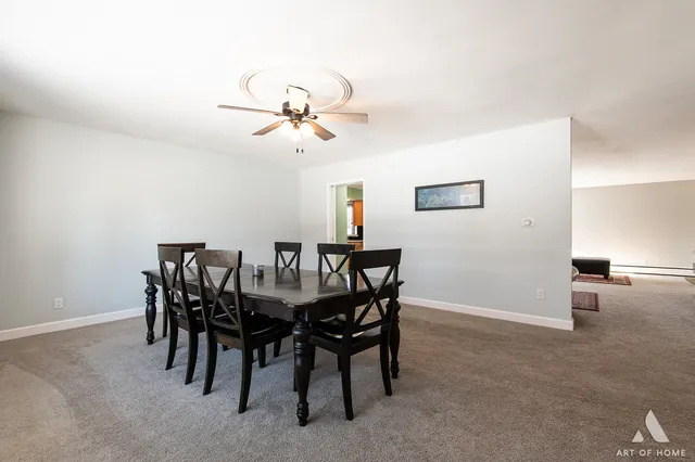 a view of a dining room that has a table and chairs