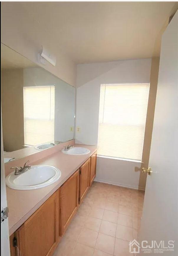 1412 Plymouth Road North Brunswick, NJ 08902 - Photo 17 of 18 a bathroom with a granite countertop sink and a bathtub