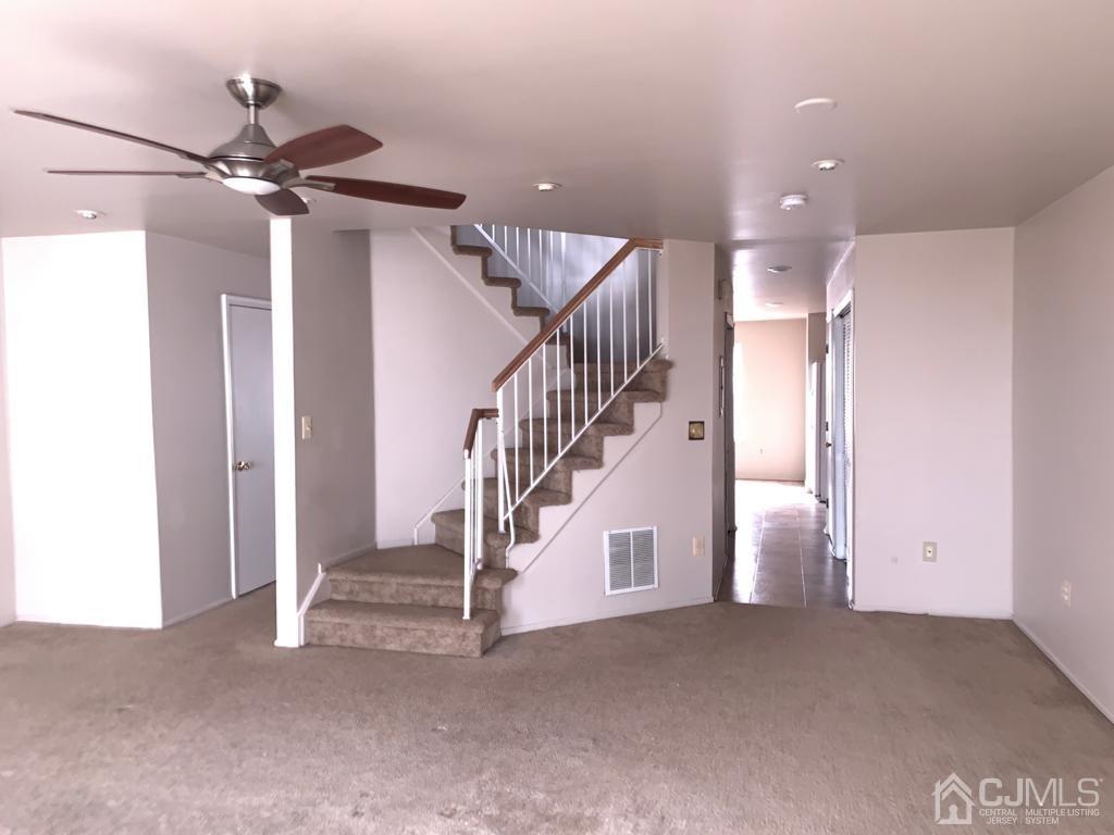 1412 Plymouth Road North Brunswick, NJ 08902 - Photo 7 of 18 a view of a hallway with staircase