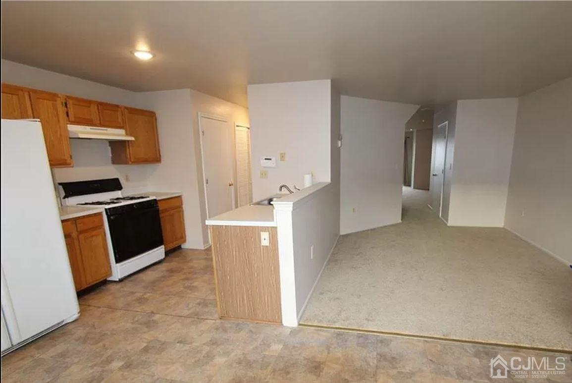 1412 Plymouth Road North Brunswick, NJ 08902 - Photo 8 of 18 a view of a kitchen with refrigerator and microwave