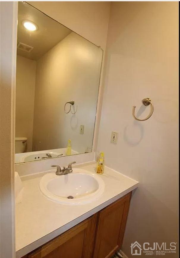 1412 Plymouth Road North Brunswick, NJ 08902 - Photo 9 of 18 a bathroom with a sink and a mirror