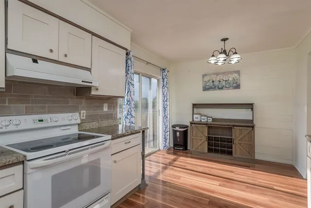 a kitchen with stainless steel appliances granite countertop a stove and a refrigerator