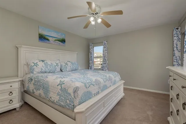 a bedroom with a bed and a ceiling fan