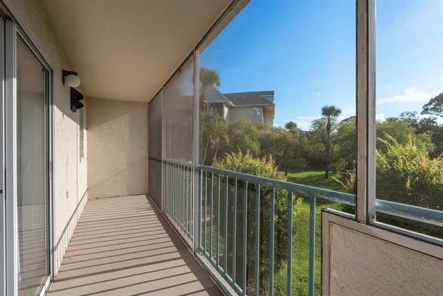 a view of a balcony with wooden floor